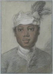 Testa di un giovane uomo nero con turbante ornato di piume