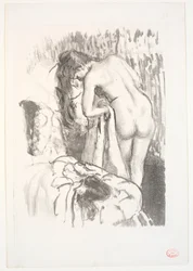 Donna nuda in piedi alla sua toilette