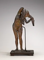 Donna che si sistema i capelli, probabilmente fine 1880-1890