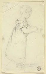 Bambina in piedi alla scrivania che scrive