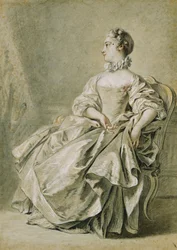 Giovane donna seduta di profilo a sinistra