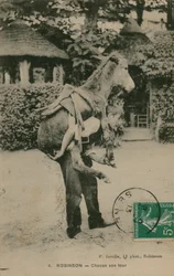 Cartolina di un uomo che porta un asino