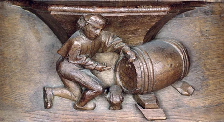 Intaglio raffigurante un uomo che mette un rubinetto su una botte, da un coro dell