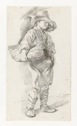 Giovane in piedi con un grande cappello, con un cesto sotto il braccio