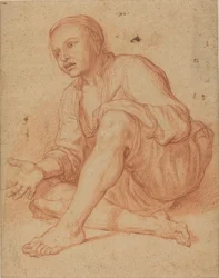 Giovane contadino seduto a terra