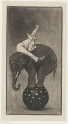 Elefante in equilibrio su una palla con un uomo sulla schiena
