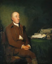 Ritratto del Dr James Hutton, seduto a tre quarti di lunghezza in una giacca marrone e pantaloni e calze bianche, un mucchio di campioni geologici sul tavolo accanto a lui