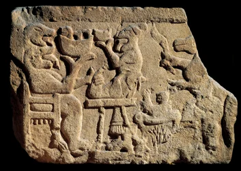 Arte iberica: bassorilievo raffigurante una scena di banchetto mitologico in cui un dio degli inferi ha due teste con la bocca aperta davanti a un altare sacrificale. Circa 500 a.C. Proveniente dalla tomba di Pozo Moro, Spagna. Madrid, Museo Arqueológico