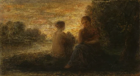 Due donne sedute vicino a un lago