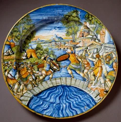 Episodio della difesa del ponte Sublicio da parte del leggendario eroe romano Orazio Coclite durante i combattimenti contro gli Etruschi. Piatto in ceramica prodotto a Urbino nella bottega Fontana, Italia. Intorno al 1560. Firenze, Museo Nazionale del