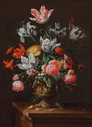 Tulipani e altri fiori in un vaso barocco in gres dipinto su un ripiano di legno