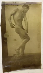 Studio di un modello maschile nudo, in piedi e leggermente piegato visto di fronte, nell