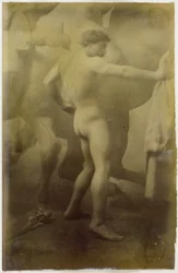 Studio di un modello maschile nudo, in piedi davanti a un murale monumentale di cavalli, nello studio di Jacques de Lalaing