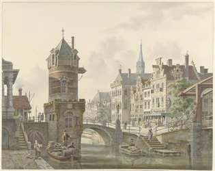 Canale in una città con una torre vicino a un ponte di pietra