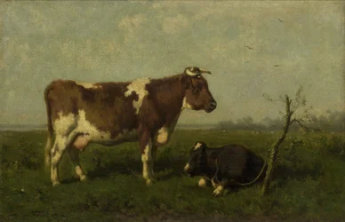 Una mucca con il suo vitello in un prato