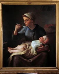Donna che dà da mangiare al suo bambino