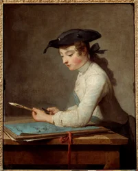 Giovane disegnatore che tempera la matita
