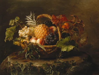 Un ananas, uva, pesche e albicocche in un cesto