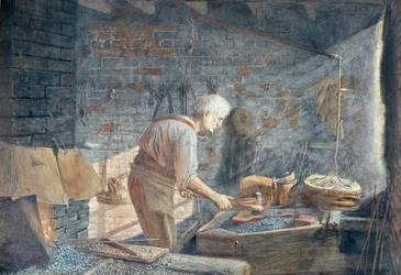 Un fabbro al lavoro nella sua fucina
