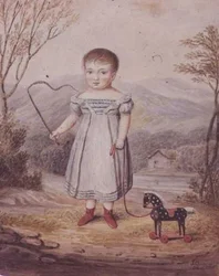 Ragazza con un cavallo giocattolo