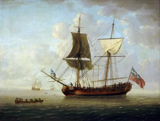 Una brigantina britannica, con bandiera rossa e Union Jack, al largo in mare calmo