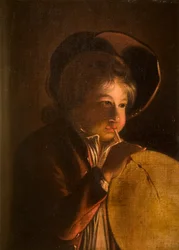 Ragazzo che soffia una vescica alla luce di una candela