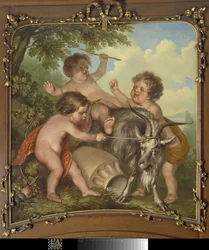 Tre bambini che giocano con una capra