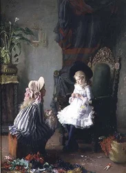 Due ragazze che vestono una bambola