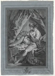 Giovane donna seduta su un letto