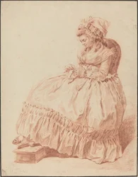 Donna seduta che cuce