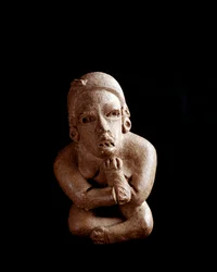 Arte precolombiana, civiltà maya, periodo preclassico: statuetta in argilla raffigurante una donna seduta con le braccia e le gambe incrociate. Da San Agustín Acasaguastlán, El Progreso, Guatemala. Altezza 10,7 cm. Città del Guatemala, Museo Nacional de