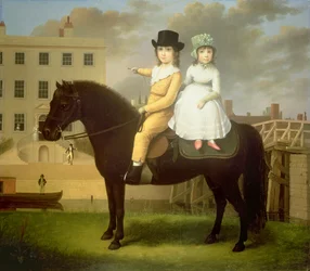 Due bambini seduti su un pony nero