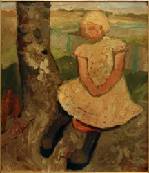 Bambino seduto sotto un albero