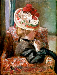 La donna con il cappello di paglia seduta su un divano di fiori