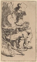 Mendicante seduto che si scalda le mani a un braciere