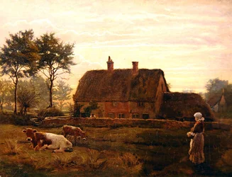 Bovini al pascolo vicino a un cottage con tetto di paglia al tramonto
