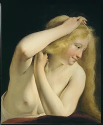 Giovane donna che si pettina ...