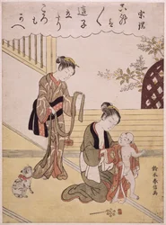 Una madre che veste il suo giovane figlio in un kimono