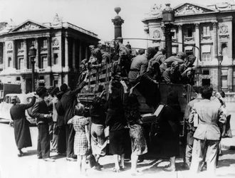 Venditori ambulanti francesi che offrono souvenir a un camion di soldati tedeschi, Parigi, 27 luglio 1940