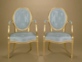 Coppia di sedie intagliate ovali dorate di Adam, rivestite in blu, c.1780