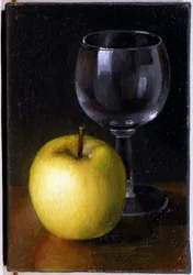 Bicchiere e mela gialla