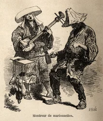 Lo spettacolo di burattini e il musicista che lo accompagna per l
