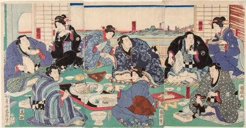 Il lottatore di sumo Sakaigawa Namiemon (a sinistra) con altri lottatori e geishe a un banchetto